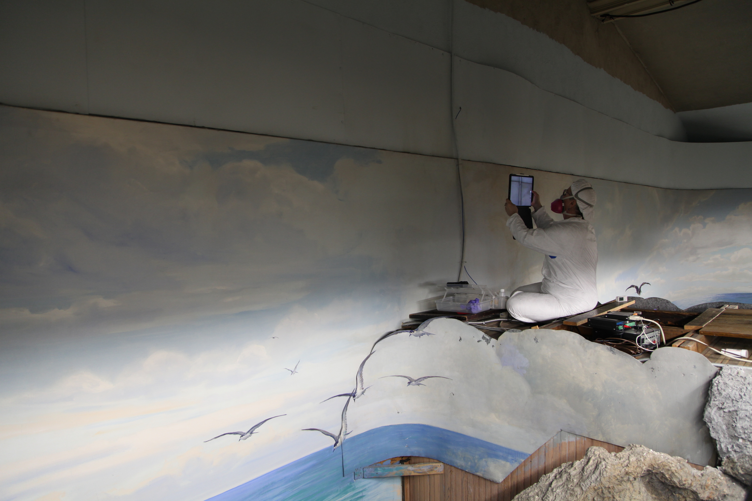 Nina examines east wall of cyclorama mural