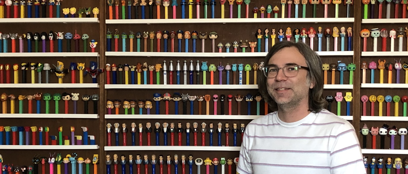 Photo of Bryan Kendall with his collection of PEZ dispensers
