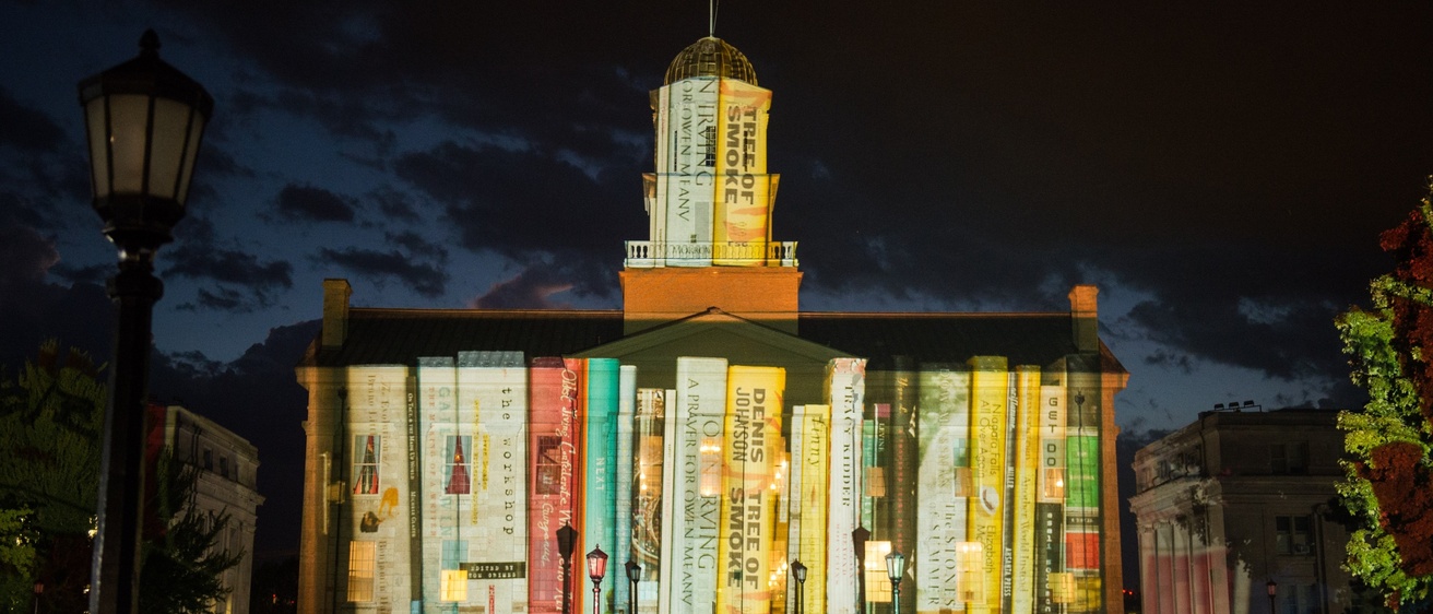 Projection of books from special collections at the University of Iowa onto the Old Capitol Museum during Gary Hoffstetter's Light Art event.