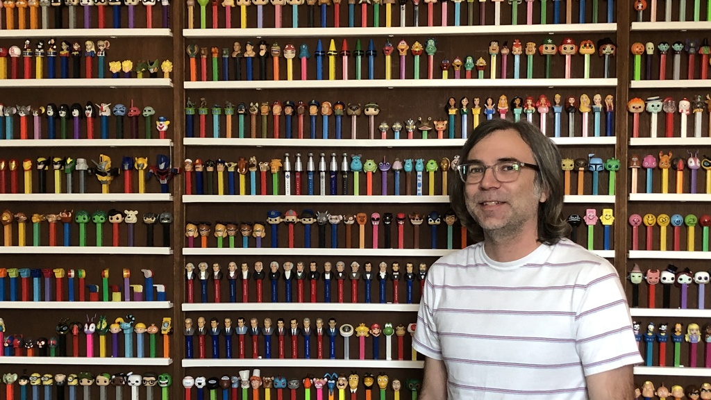 Photo of Bryan Kendall with his collection of PEZ dispensers